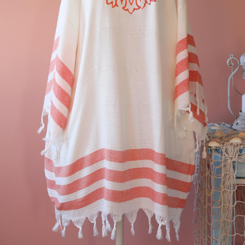 Women hand-made dress with orange stripes and tassels at the borders
